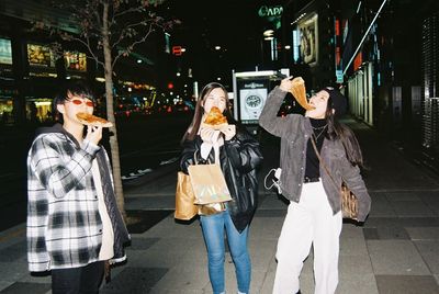 Group of people on street in city at night