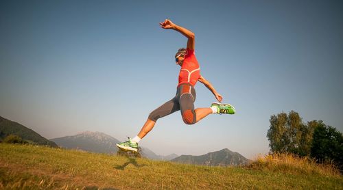 Man jumping in mid-air against sky