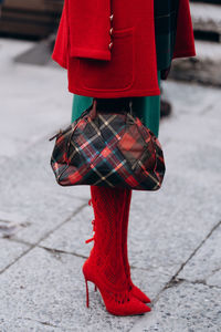 Low section of woman standing on street