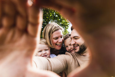 Happy family behind finger frame