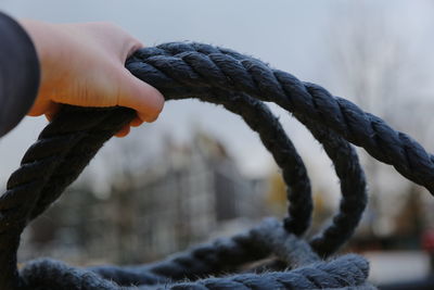 Close-up of hand holding rope