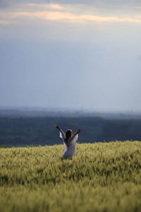 Man standing in field against sky