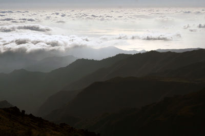 Morning mountain scenery with gradient grey color peaks and low clouds. sunrise. portugal, madeira