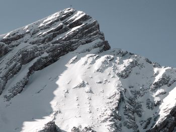 Scenic view of snowcapped mountains against clear sky