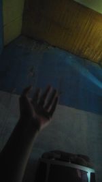 Shadow of person hand on wall