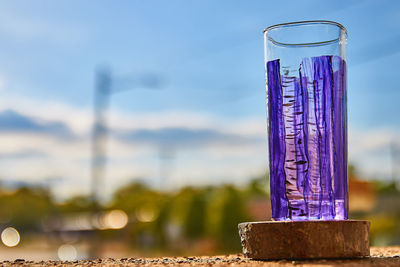 Close-up of glass against blue sky