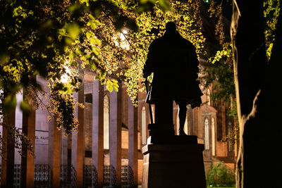 Rear view of man outside temple against building