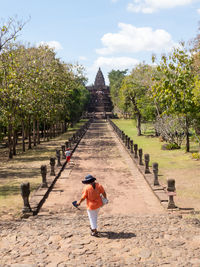 Rear view of men walking in temple