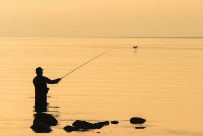 Sea fly fishing in the sunset at the sea