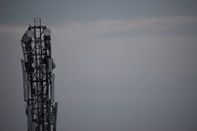 Low angle view of communications tower against sky