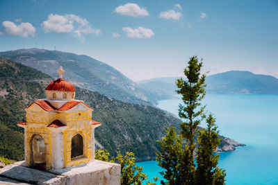 Church at beach against mountains and sky