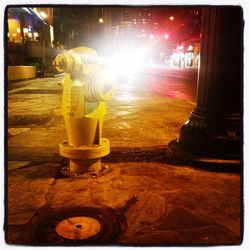 Illuminated lamp post at night