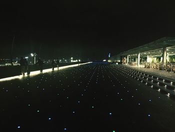 Illuminated tunnel at night