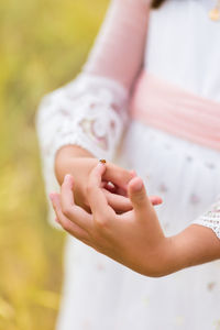 Midsection of woman holding hands