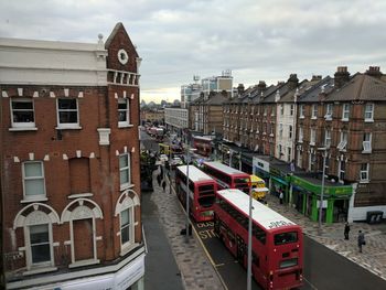 High angle view of double-decker buses on street amidst buildings in city