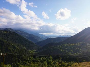 Scenic view of mountains against cloudy sky