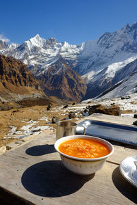 Food in bowl on table at mountain during winter