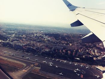 Cropped image of airplane flying over cityscape