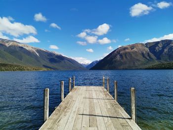 Pier over lake against sky