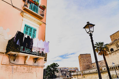 Low angle view of street light against building