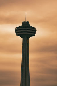 Low angle view of tower against cloudy sky