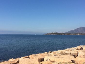 Scenic view of sea against clear blue sky