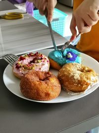 Close-up of hand holding ice cream on table