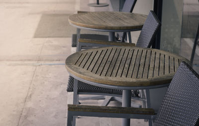 Close-up of chairs and table at sidewalk cafe