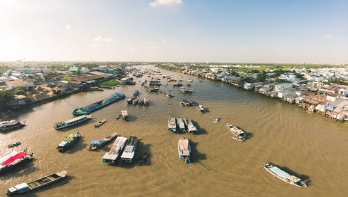 High angle view of sea and cityscape against sky