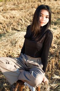 Portrait of a beautiful young woman in field