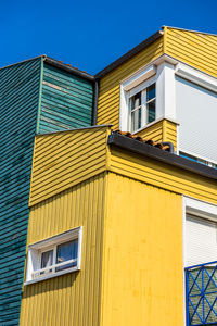 Low angle view of yellow building against sky