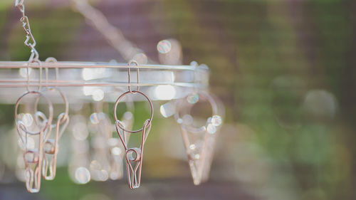 Close-up of clothespins hanging outdoors