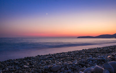 Scenic view of sea against clear sky during sunset