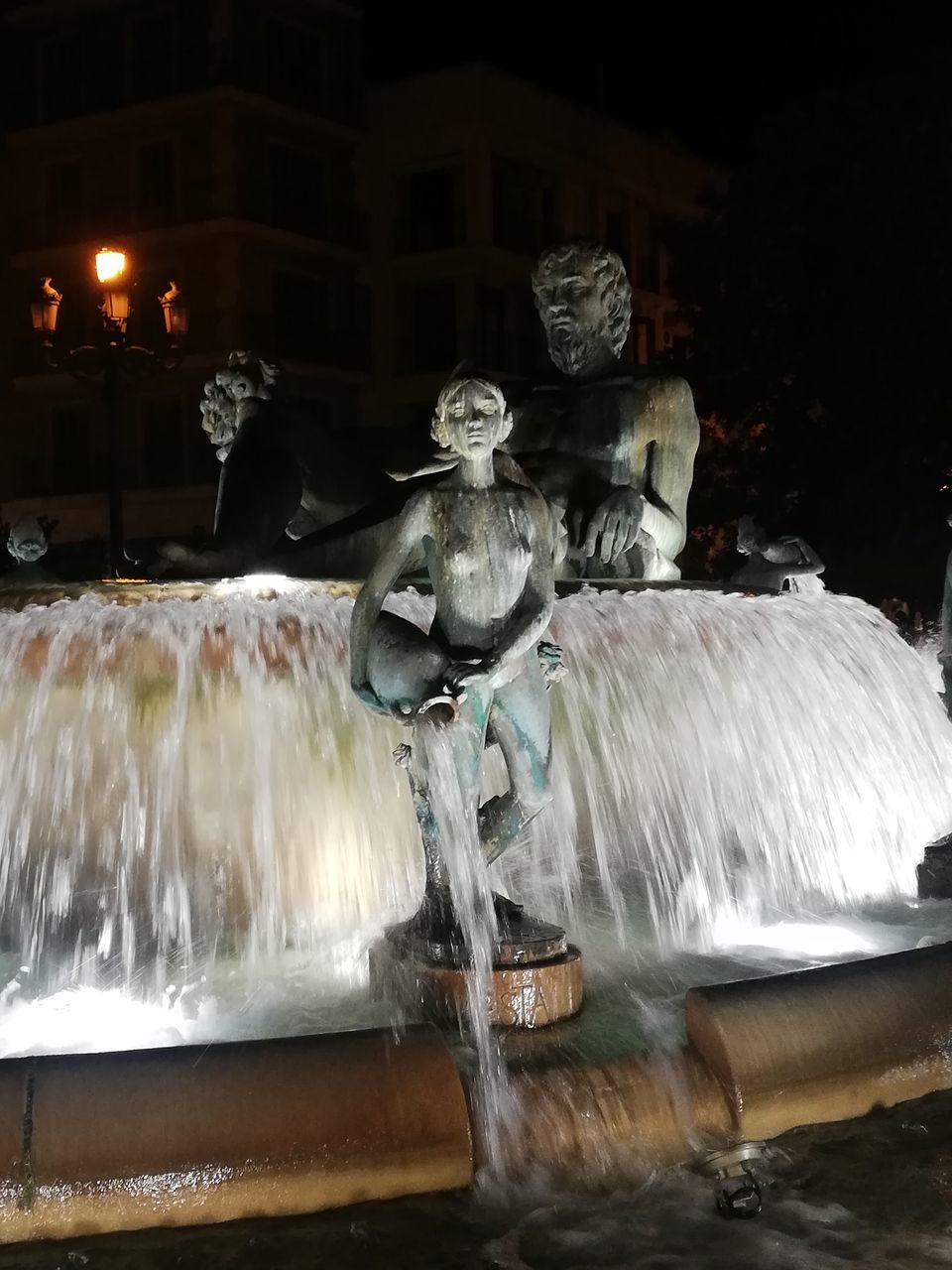 STATUE BY FOUNTAIN AT NIGHT DURING FESTIVAL