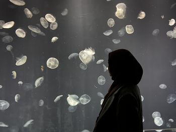 Side view of woman standing at bubbles