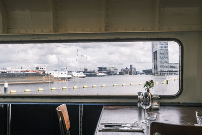 Cityscape against sky seen through glass window