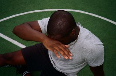 High angle view of man sitting on grass