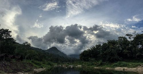 Scenic view of mountains against cloudy sky