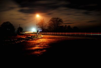 View of illuminated street lights at night