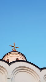 Low angle view of traditional orthodox church building against clear blue sky