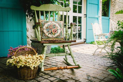 Empty chair by basket in back yard