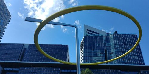Low angle view of modern buildings against blue sky