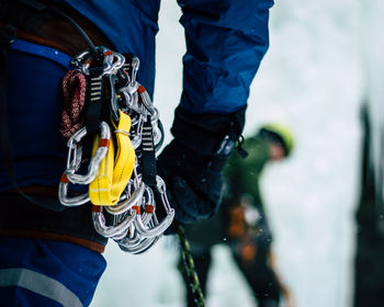 Midsection of man with safety harness