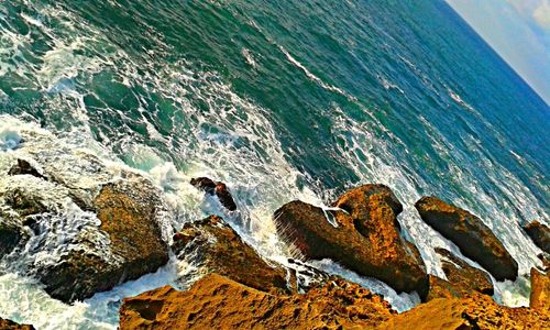 Waves splashing on rocky shore