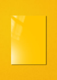 Close-up of yellow paper against wall