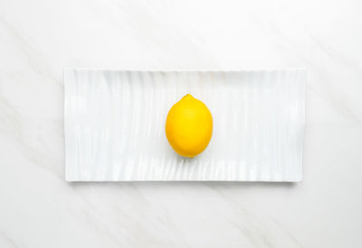 Close-up of orange fruit against white background