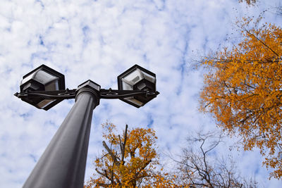 Low angle view of street light against cloudy sky