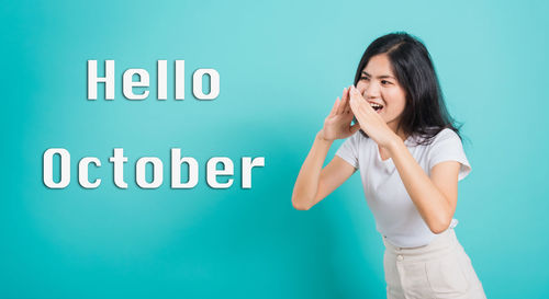 Woman standing against blue background