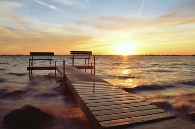 Scenic view of beach against sky during sunset