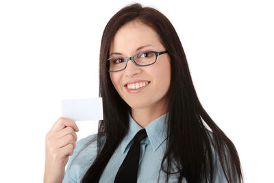 Portrait of smiling young woman against white background